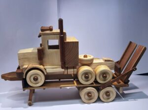 Wood model of Mack semi loaded on a trailer